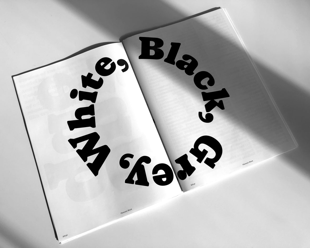 White page of a magazine with the workds White, Black and Grey in a circle