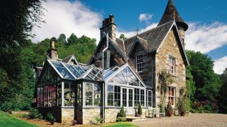 large conservatory attached to old stone house