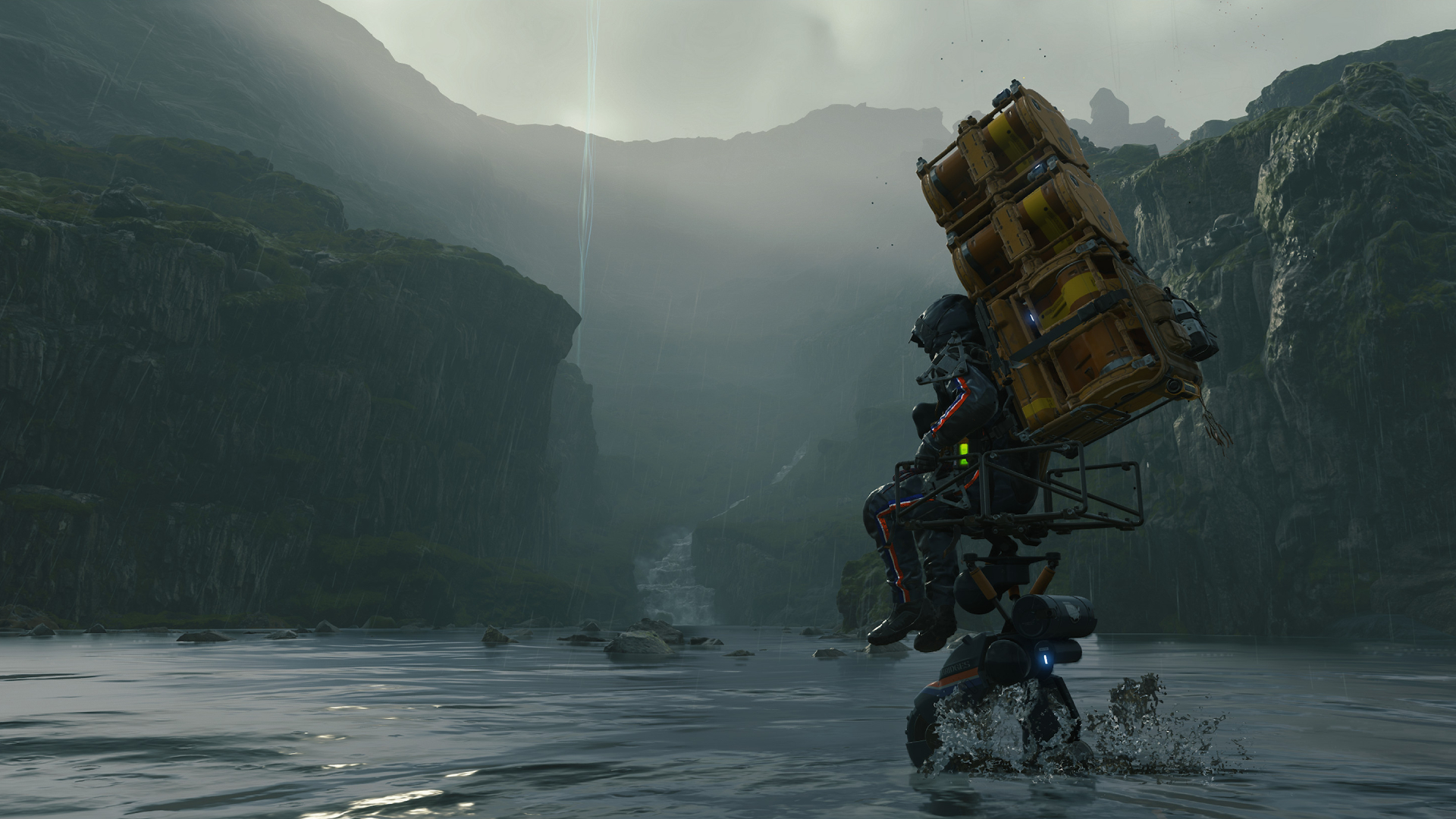 Free Epic games — In Death Stranding, protagonist "Sam" Porter Bridges crosses a lake towards a misty hillscape, riding atop a transport drone.