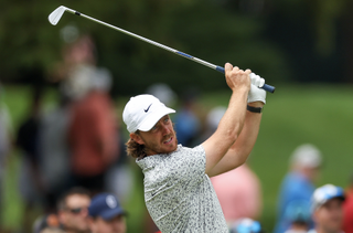 Tommy Fleetwood holds his finish after hitting an iron shot