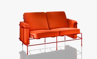 Bright, bold orange two-seater sofa with red metal frame