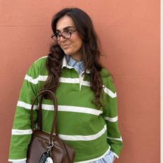 Influencer izabellalily in a green and white polo jumper layered on top a blue check shirt 