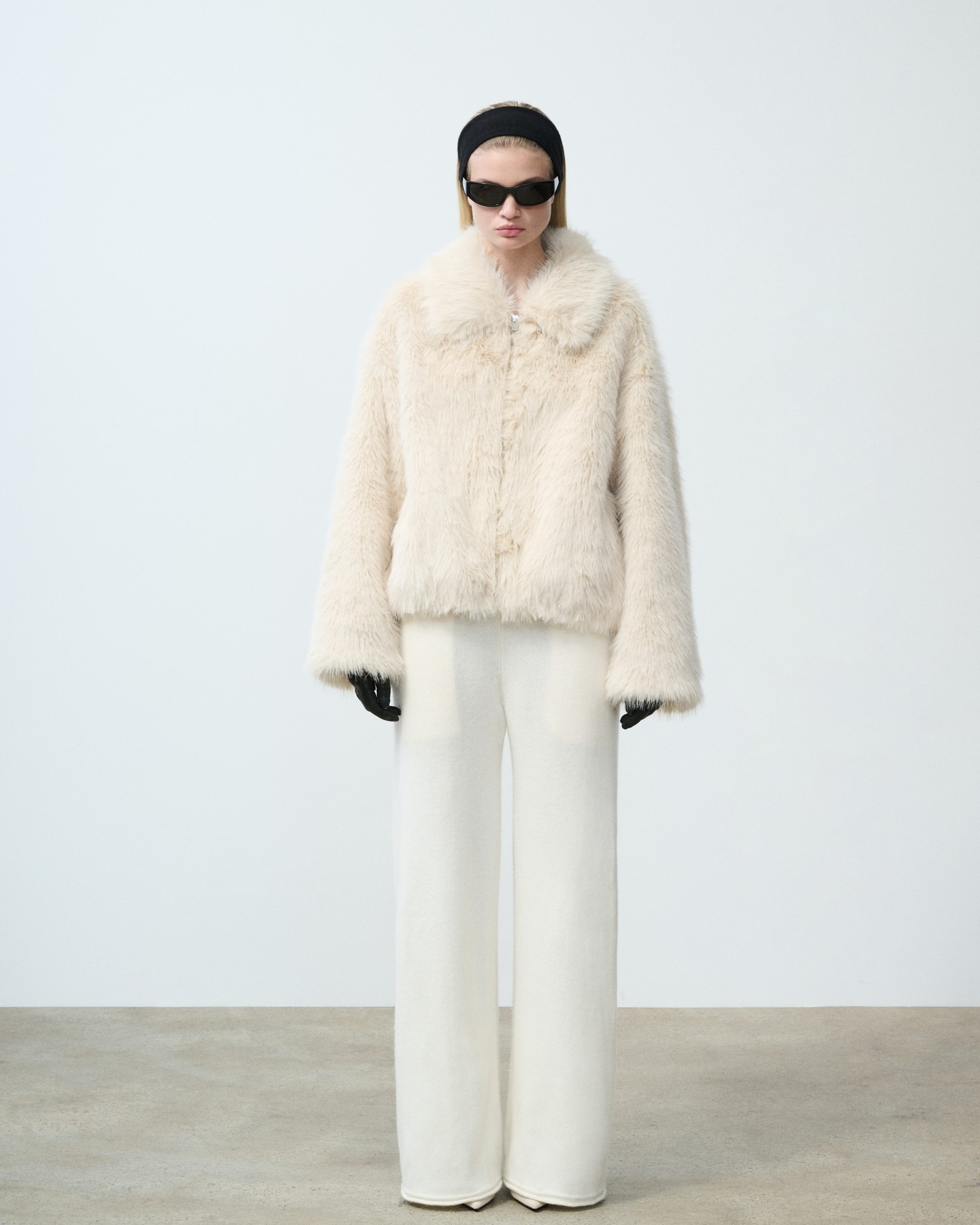 Model wears SRG Atelier's Erin Faux Fur Jacket and Suki Knit Pants.