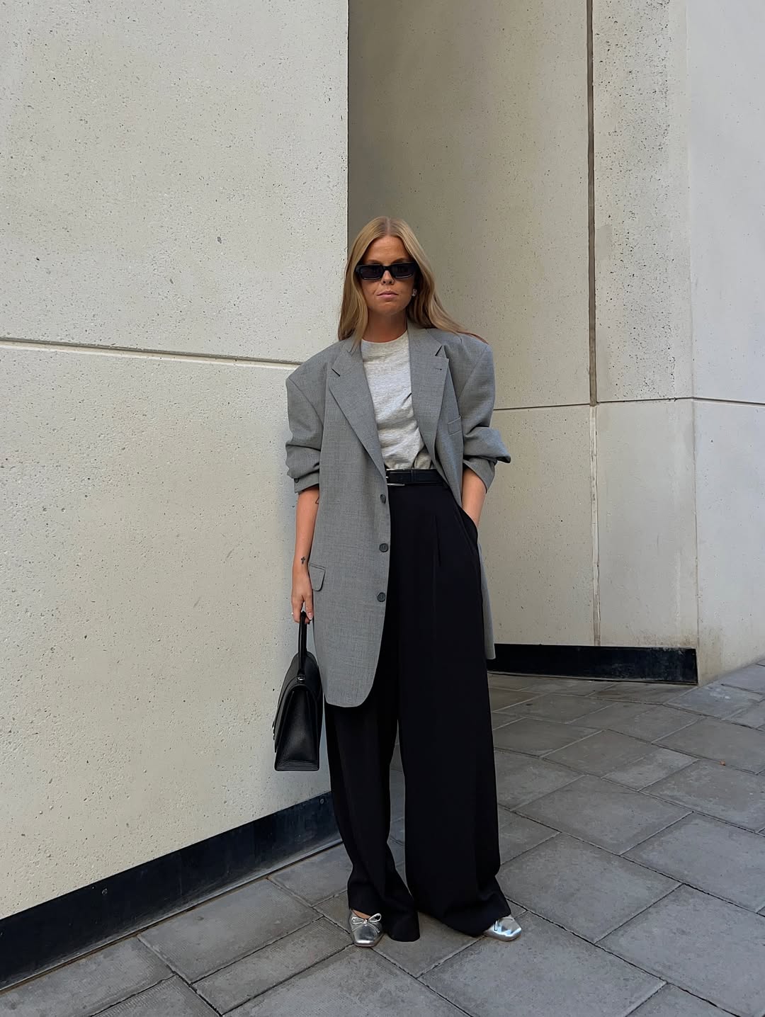 Influencer Hanna Johansson wearing black trousers and silver shoes.