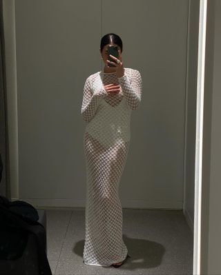 Sasha Mei wearing a sheer crochet maxi dress from Victoria Beckham x Mango.