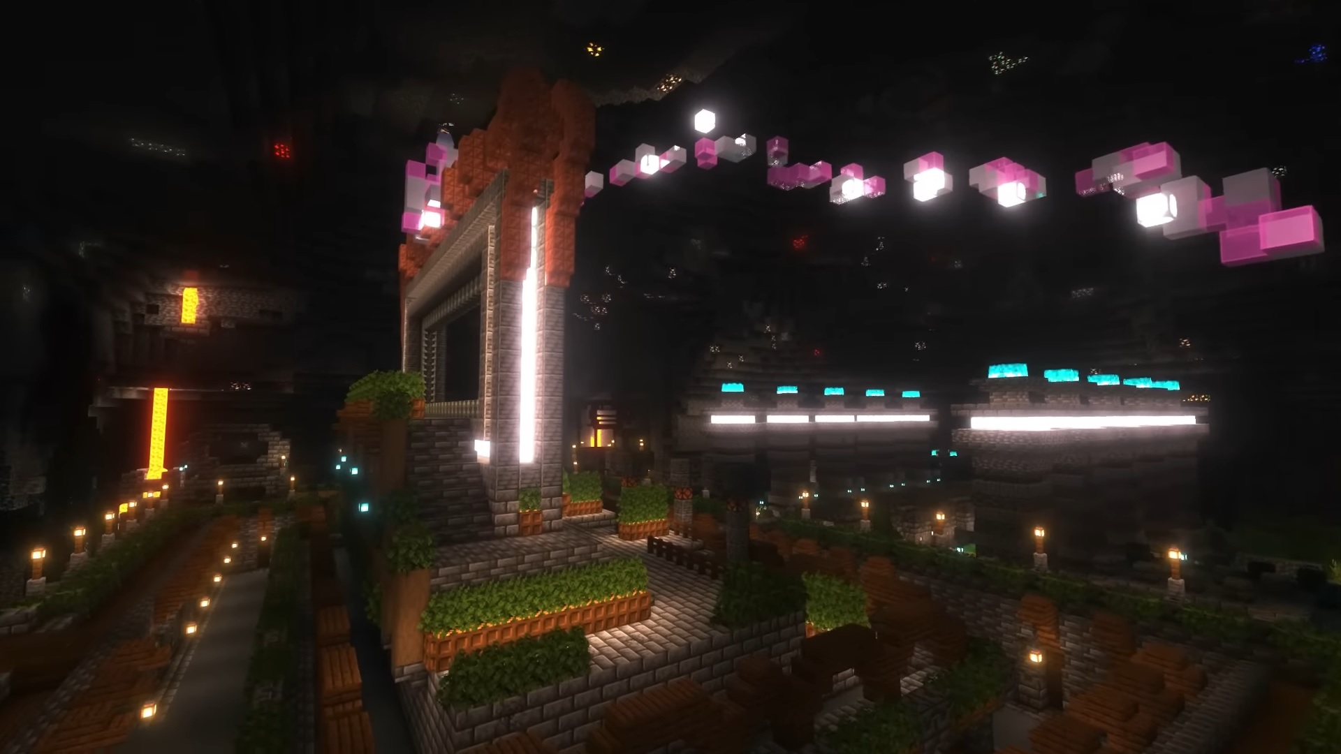 Minecraft ancient city build - A large central portal surrounded by light blocks, with stained glass and sea lamps on top, surrounded by greenery.