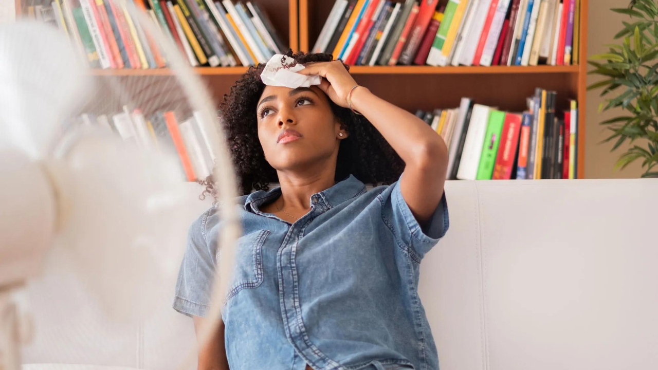 Woman struggling in the heat, representing the need for cooling gadgets.