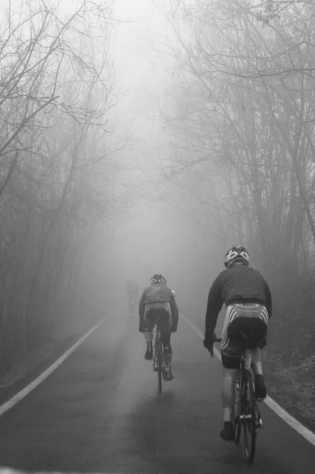 Riders disappear into the thick fog.