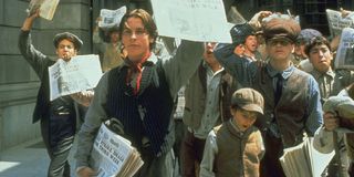 The cast of Newsies during a paper strike in Newsies.