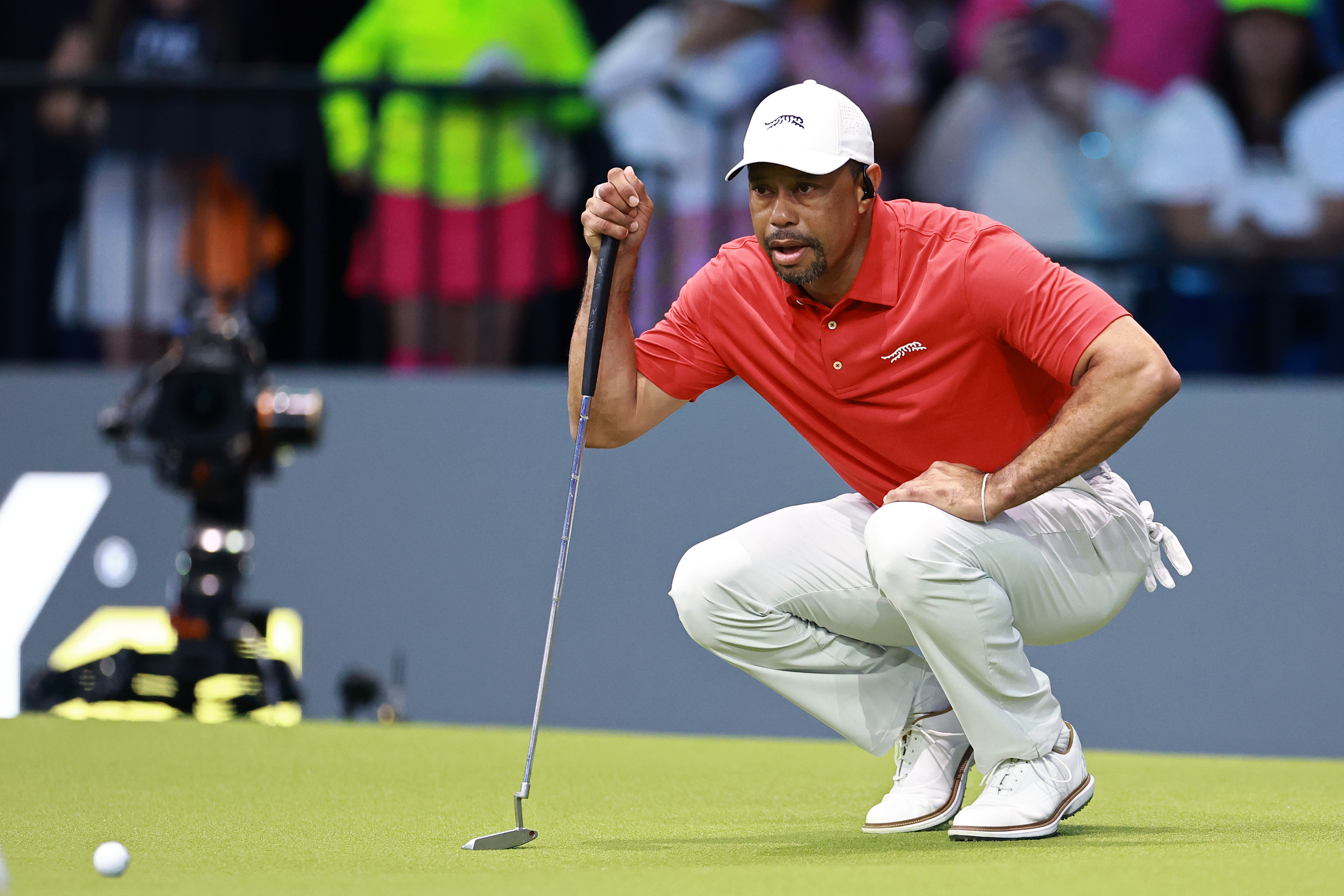 Tiger Woods lines up a putt