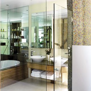 en suite bathroom with floor tiles and bathtub