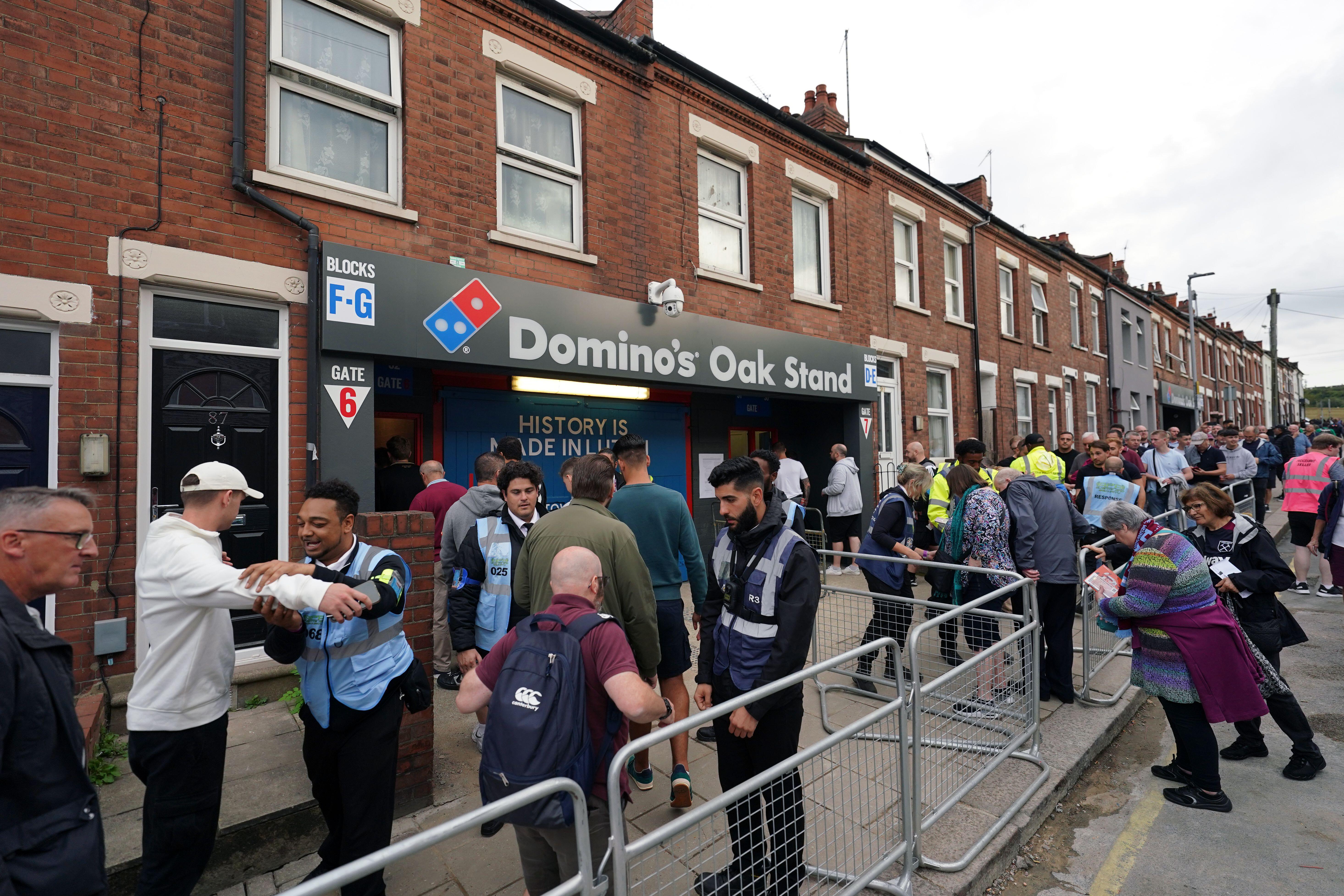 Away fans queue to enter the Oak Road Stand at Kenilworth Road, Luton