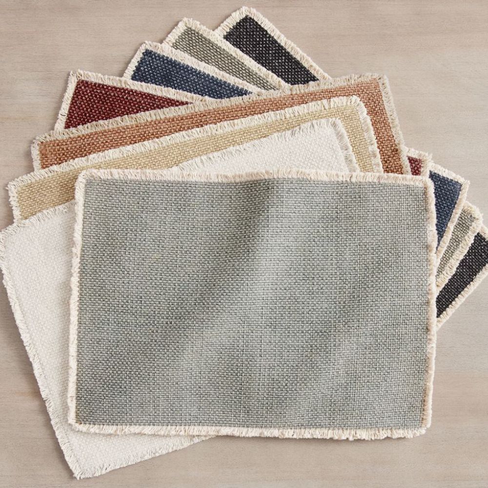 Set of cotton placemats with fringed edging in muted shades