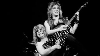 Ozzy Osbourne lifting Randy Rhoads on his shoulder onstage in 1982
