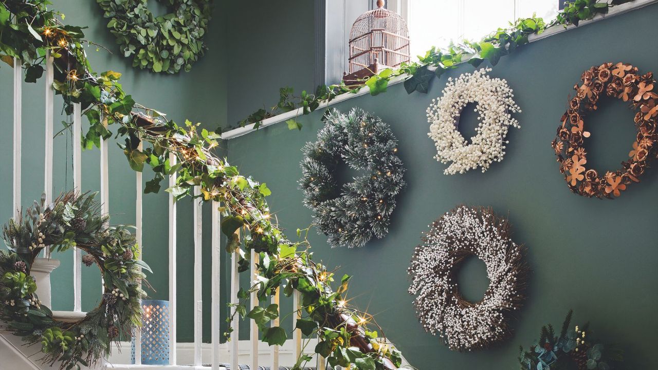 Olive green hallway covered in natural wreaths