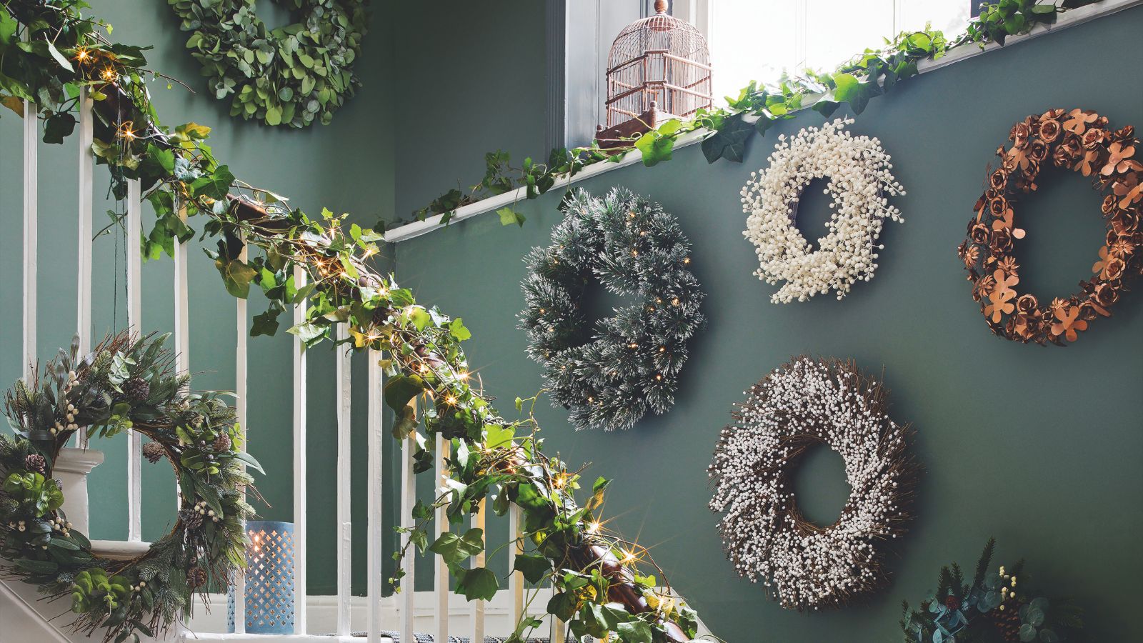 Olive green hallway covered in natural wreaths