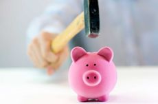 A man breaking a piggy bank