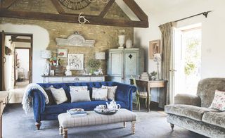 Blue velvet sofa in a traditional converted barn