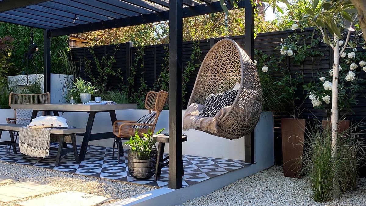 an outdoor seating area with hanging chair