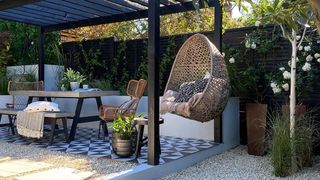 an outdoor seating area with hanging chair