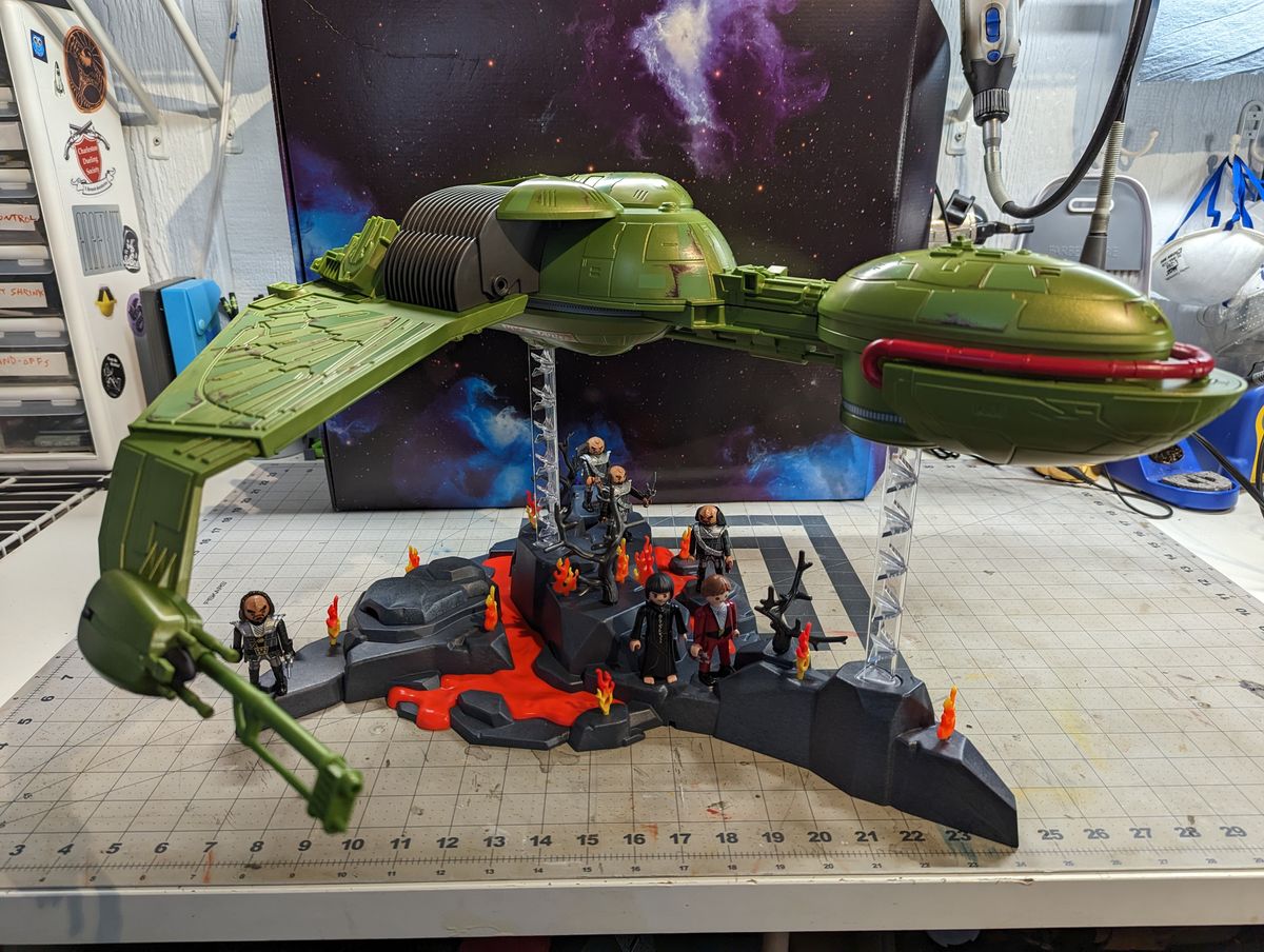 a child assembles a klingon bird of prey on a workbench
