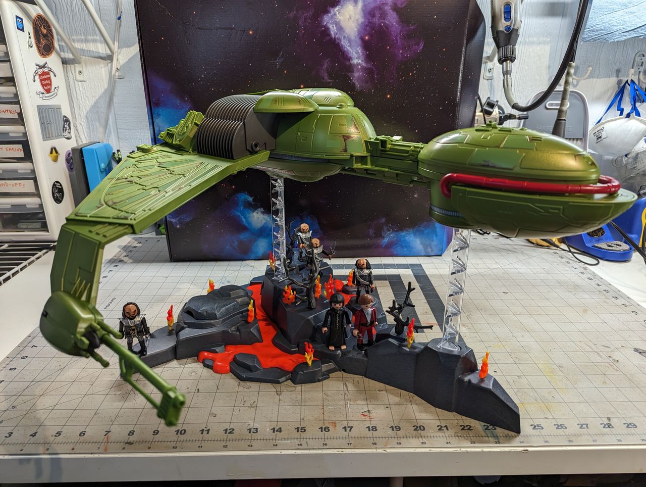 a child assembles a klingon bird of prey on a workbench