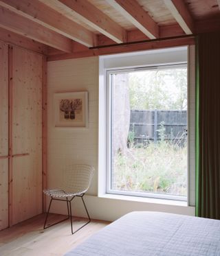 Six Columns House by 31/44 Architects, wood-lined bedroom with window
