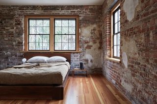 bedroom with red brick wall