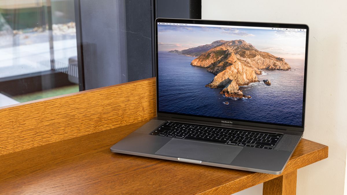 An Apple Mac sat on an office bench