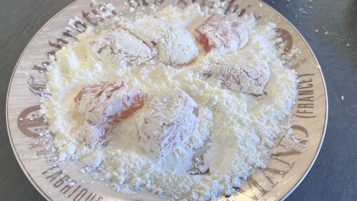 Coating being added to chicken pieces