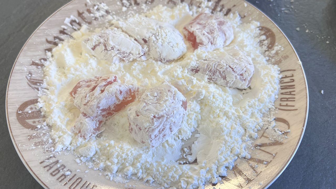 Coating being added to chicken pieces