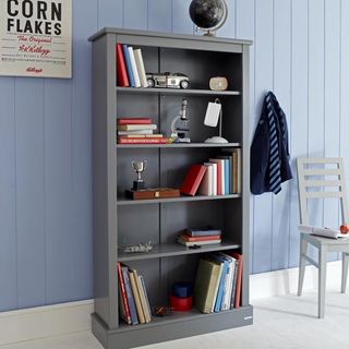 grey bookcase near hanging cloth and chair
