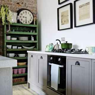 grey shaker kitchen with green vintage bookcase in corner
