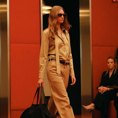 a model in the kallmeyer runway show wearing a tie shirt and cargo pants