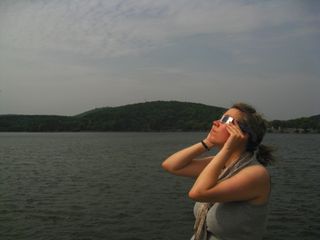 Watching the partial phase of a total solar eclipse on July 22, 2009, in China.