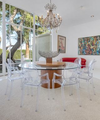 Large dining room with see-through table and artwork