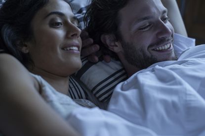 Couple watching porn together in bed - stock photo