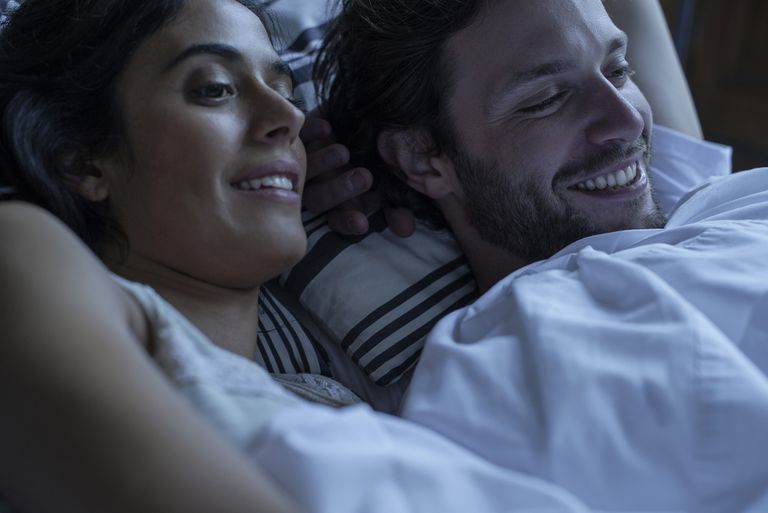 Couple watching porn together in bed - stock photo