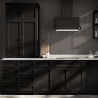 A dark kitchen with a white countertop
