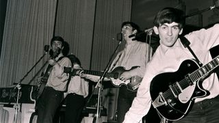 Photo of (L-R) singer-guitarist John Lennon, singer-bassist Paul McCartney and guitarist George Harrison of The Beatles, live onstage circa May 1962 at the Star-Club in Hamburg, Germany