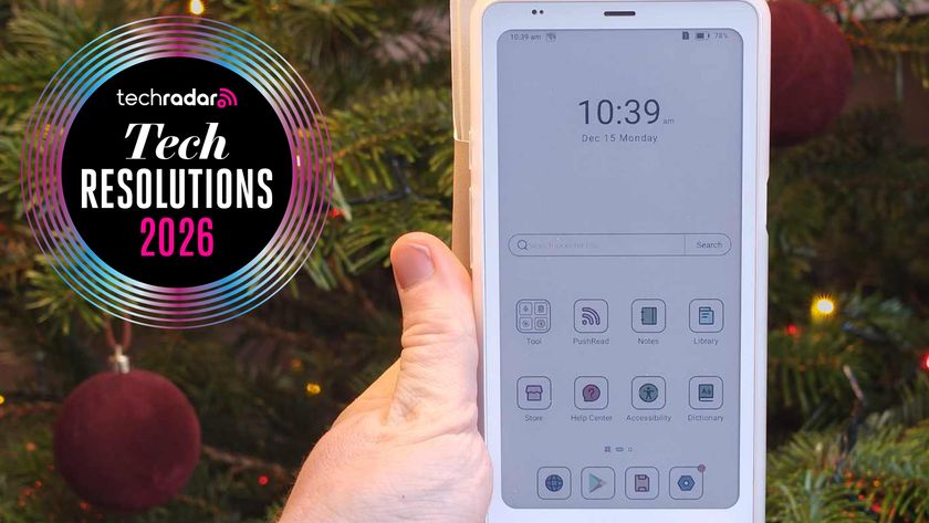 A hand holding the Boox Palam 2 Pro in front of a Christmas tree