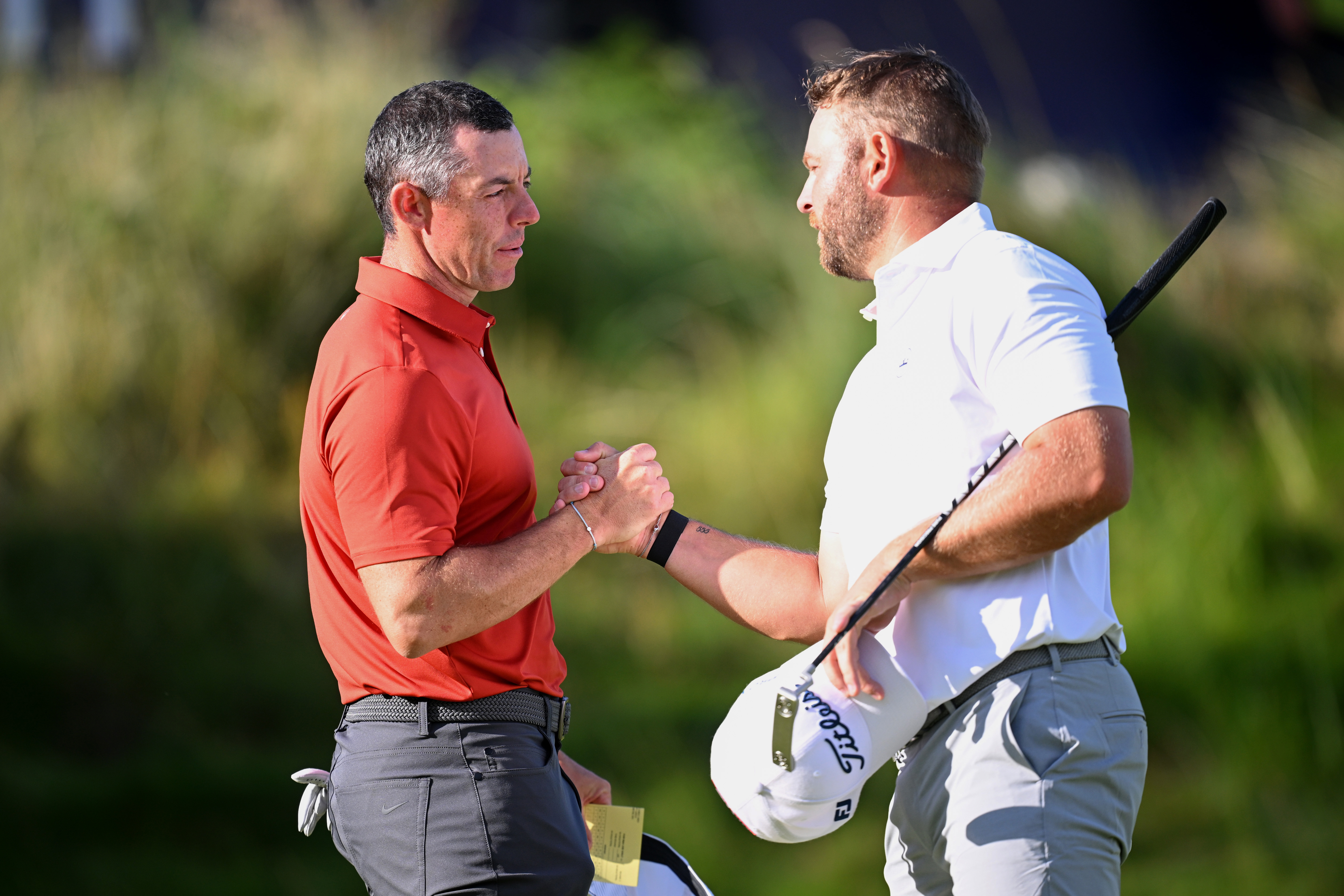 Rory McIlroy and Jordan Smith shake hands at the end of round three of the 2025 Open at Royal Portrush