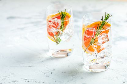 glasses of flavoured gin and rosemary sprigs