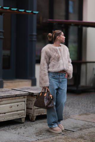 street style shot of jeans, uggs and a fur jacket