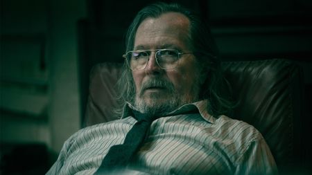 Gary Oldman as Jackson Lamb, sitting at his desk in Slow Horses Season 6