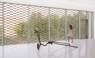 The gallery's stark white interior allows the view beyond the ceramic tiles to take centre stage