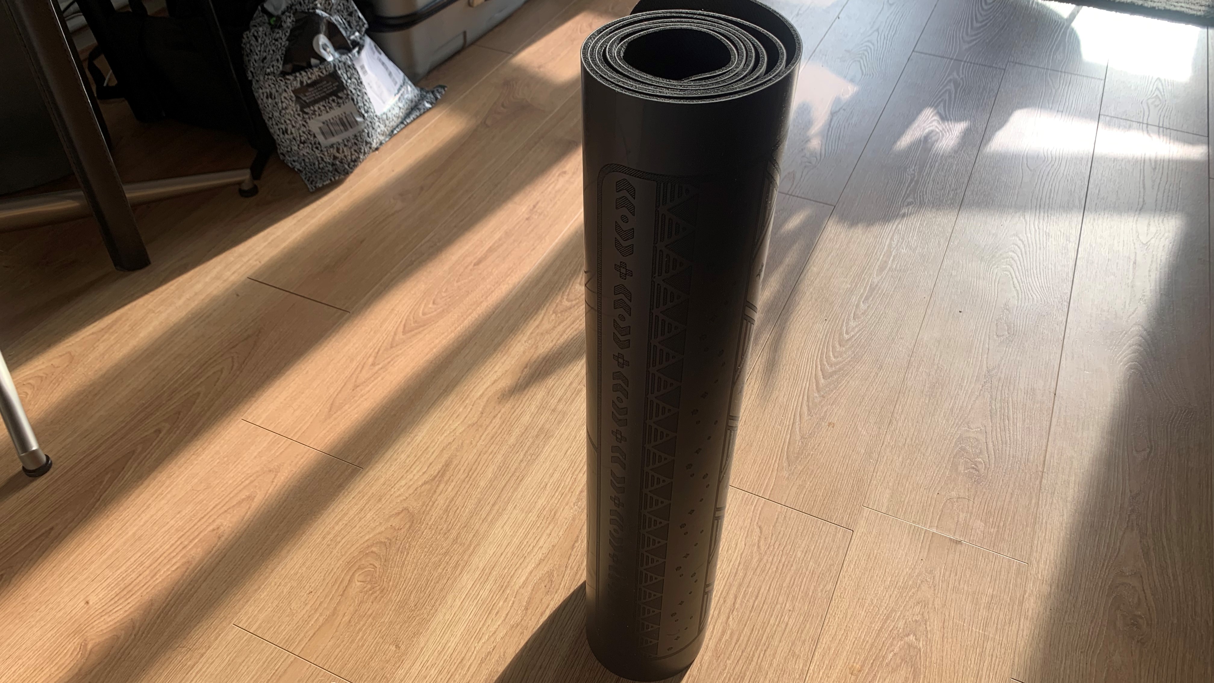 Naked Yogi mat rolled up, being tested by Live Science