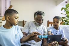 Man playing video games with grandsons