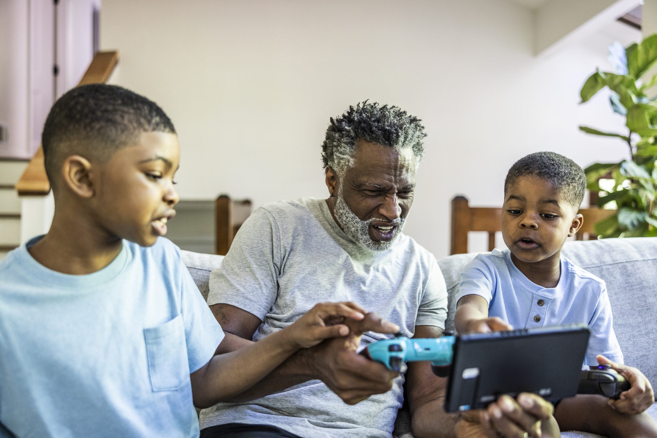 Man playing video games with grandsons