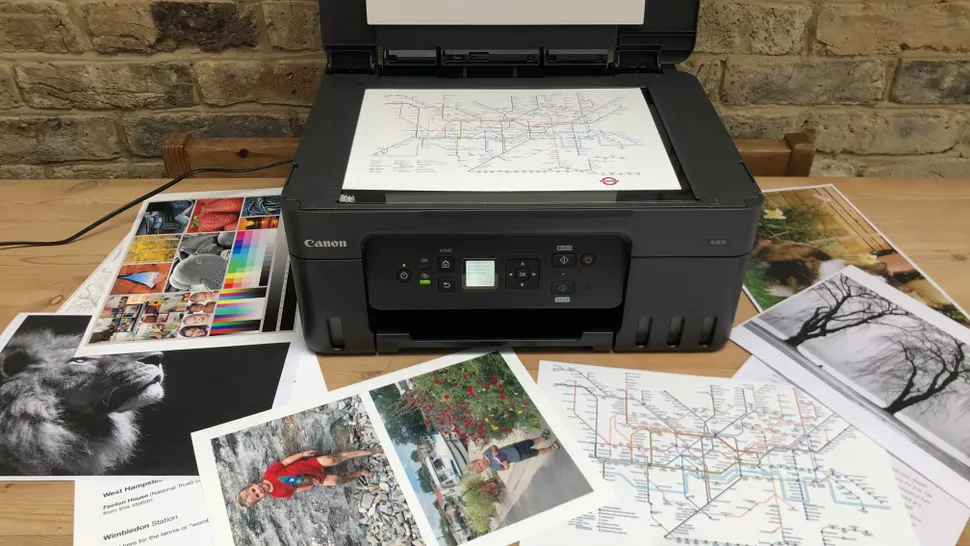 The Canon MegaTank G3270 scattered with print-outs in a home office during our testing